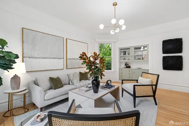 a living room with furniture a flat screen tv and a potted plant