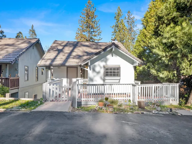 a front view of a house with a garden and pathway