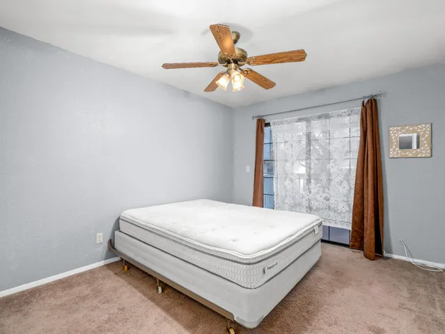 a bed sitting in a bedroom next to a window