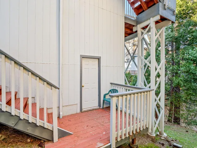 a view of a balcony with wooden floor and stairs