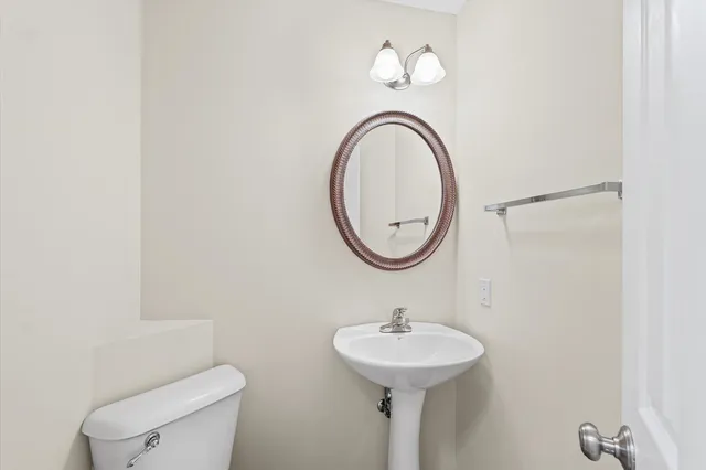 a bathroom with a sink a mirror and a toilet