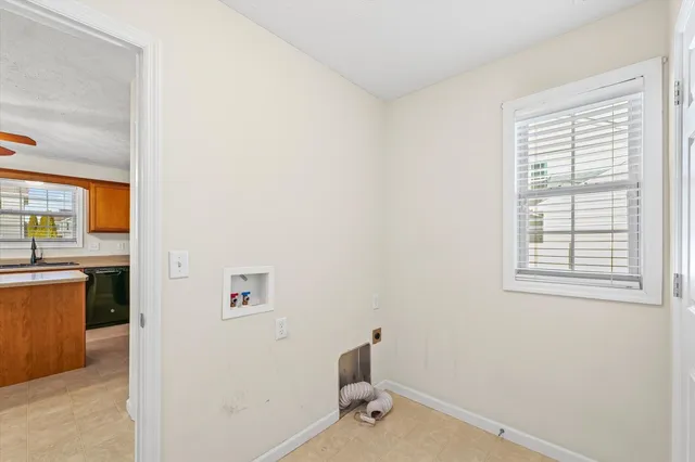 a bathroom with a bathtub and a window