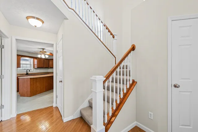 a view of entryway and hall with wooden floor