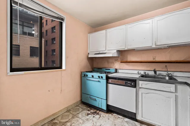 a kitchen with granite countertop cabinets stainless steel appliances and a sink