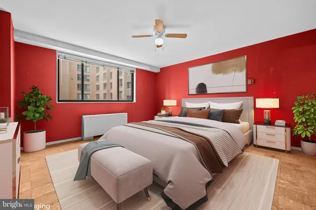a bedroom with a bed lamp and a potted plant