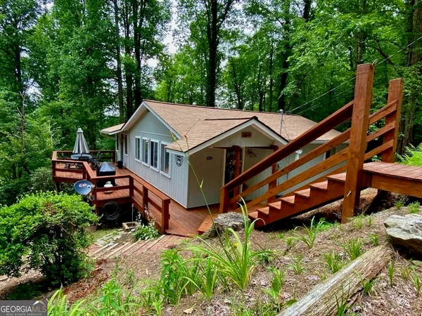 an aerial view of a house with roof deck front of house