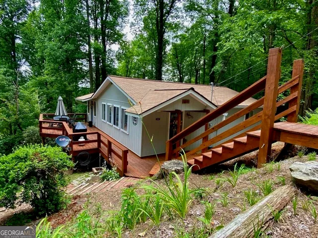 an aerial view of a house with roof deck front of house