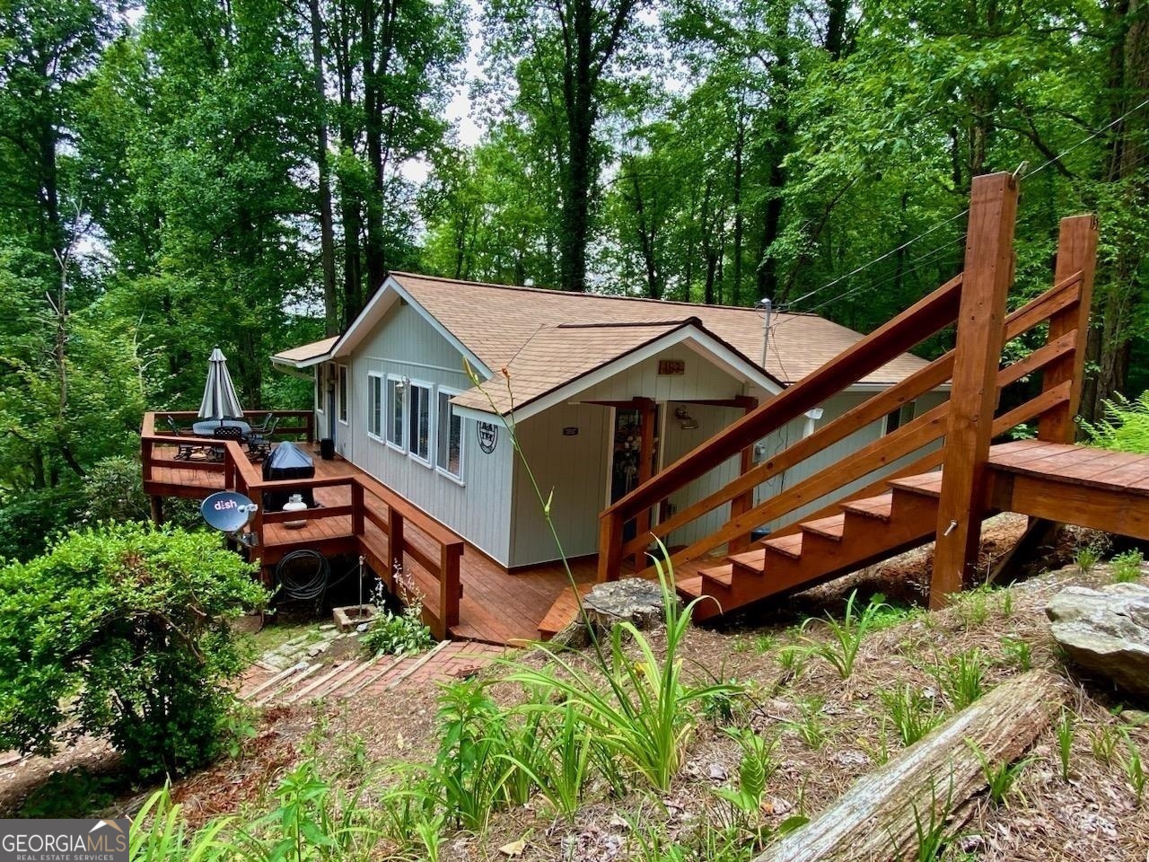 an aerial view of a house with roof deck front of house
