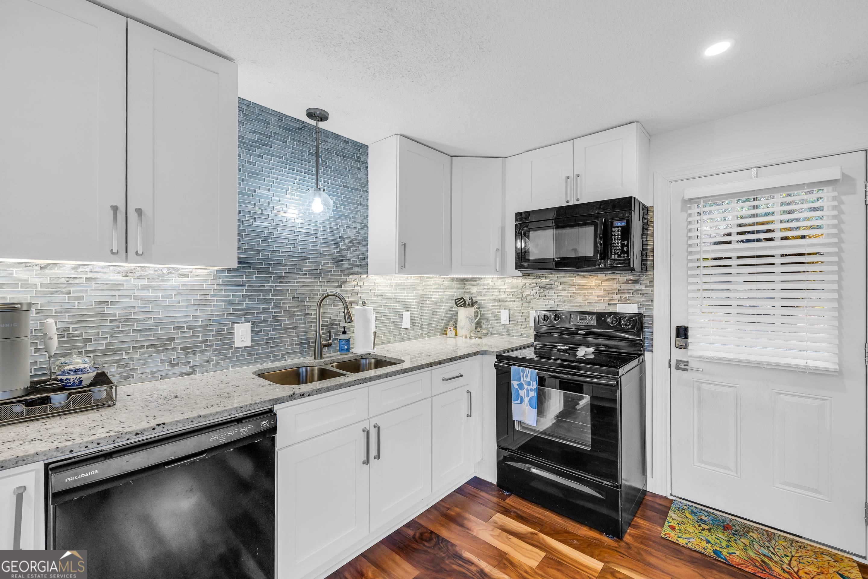 153 Coleman Heights Lane Rabun Gap, GA 30568 - Photo 17 of 57 a kitchen with a sink stove and microwave