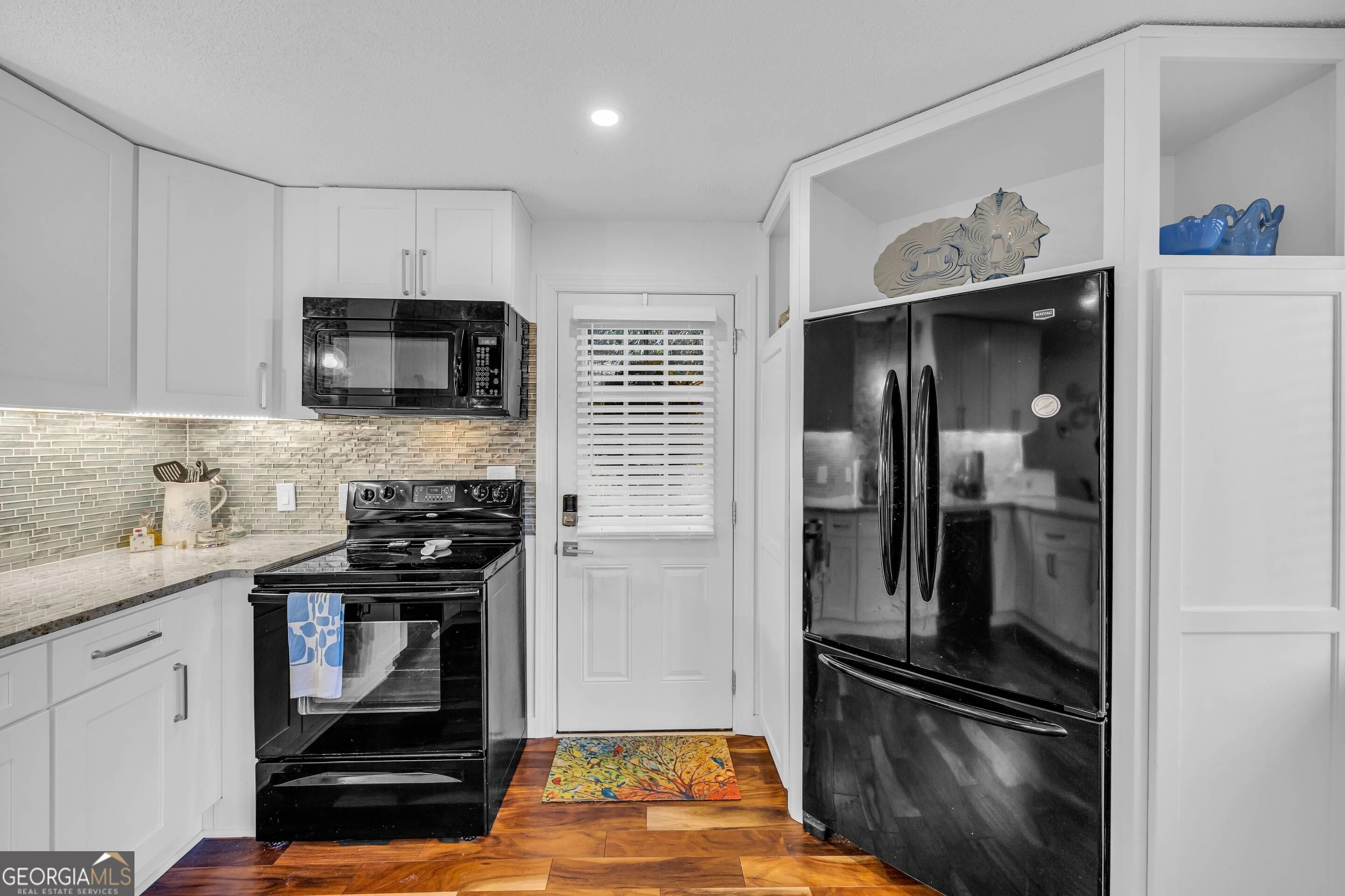 153 Coleman Heights Lane Rabun Gap, GA 30568 - Photo 19 of 57 a kitchen with a refrigerator stove and sink