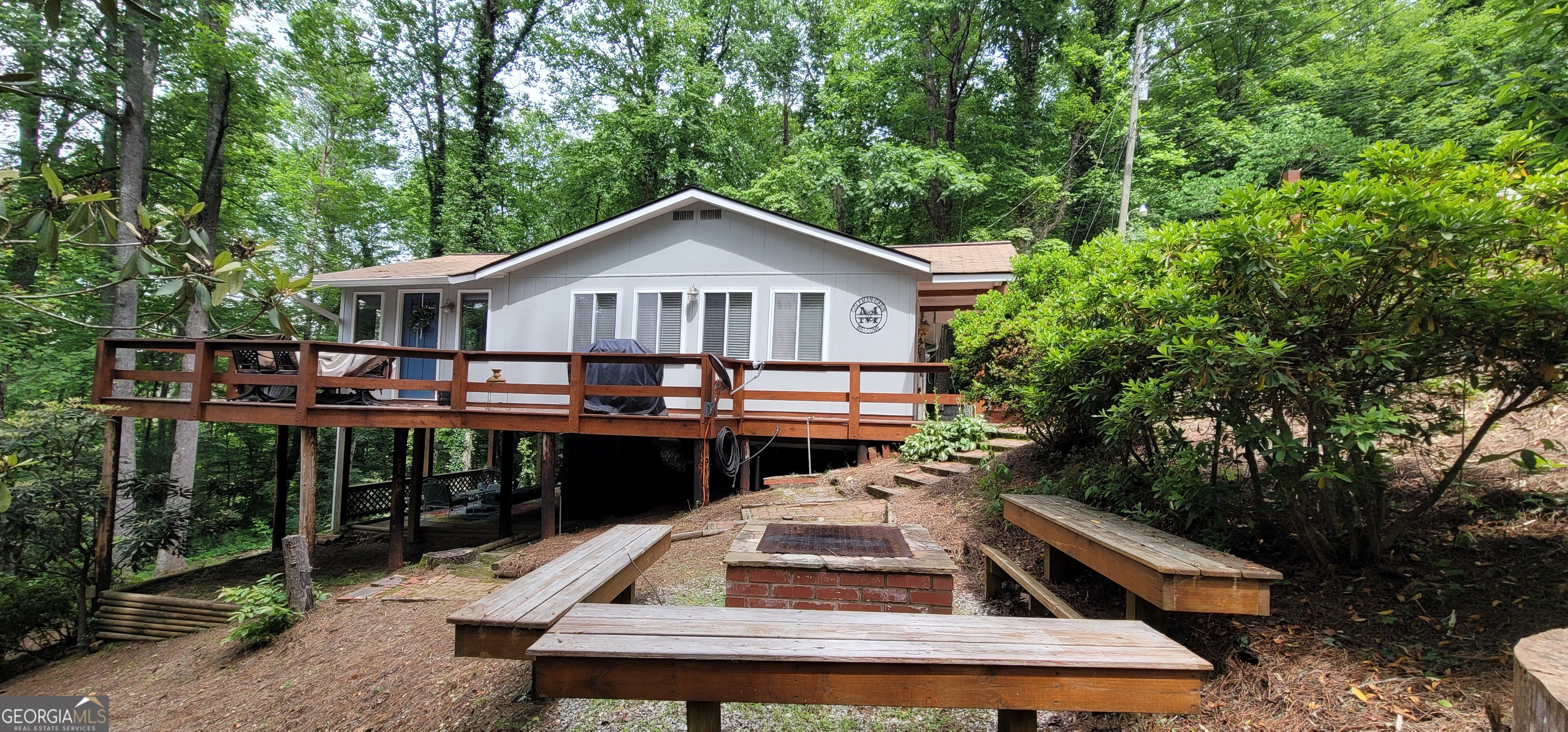 153 Coleman Heights Lane Rabun Gap, GA 30568 - Photo 3 of 57 a front view of a house with a yard balcony and outdoor seating