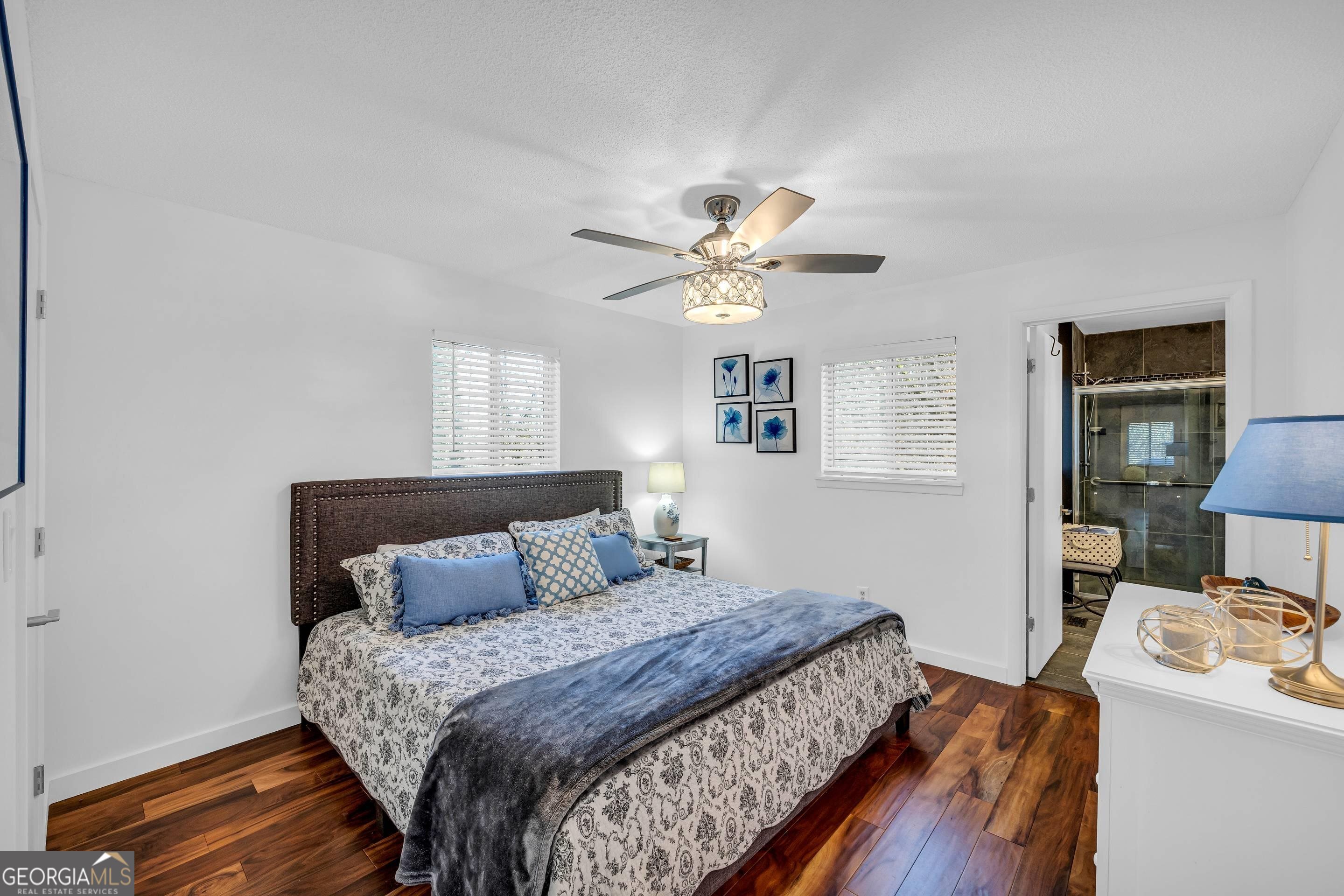 153 Coleman Heights Lane Rabun Gap, GA 30568 - Photo 36 of 57 a bedroom with a bed and a chandelier
