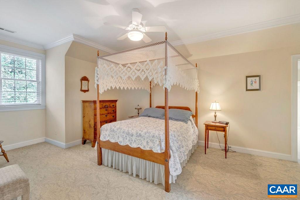 3164 Darby Road Keswick, VA 22947 - Photo 41 of 47 a bedroom with a bed lamp and a window