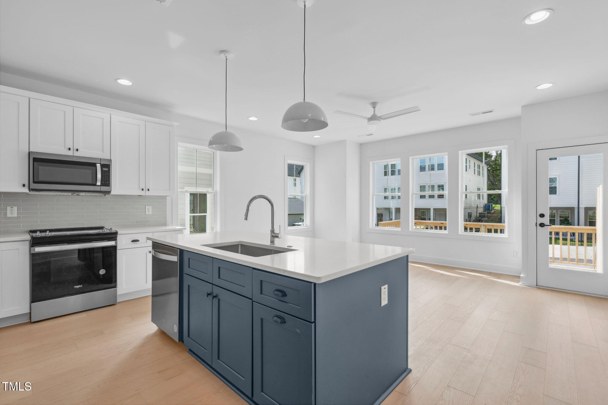 5053 Lundy Drive, Unit 101 Raleigh, NC 27606 - Photo 2 of 47 a kitchen with sink stove and microwave
