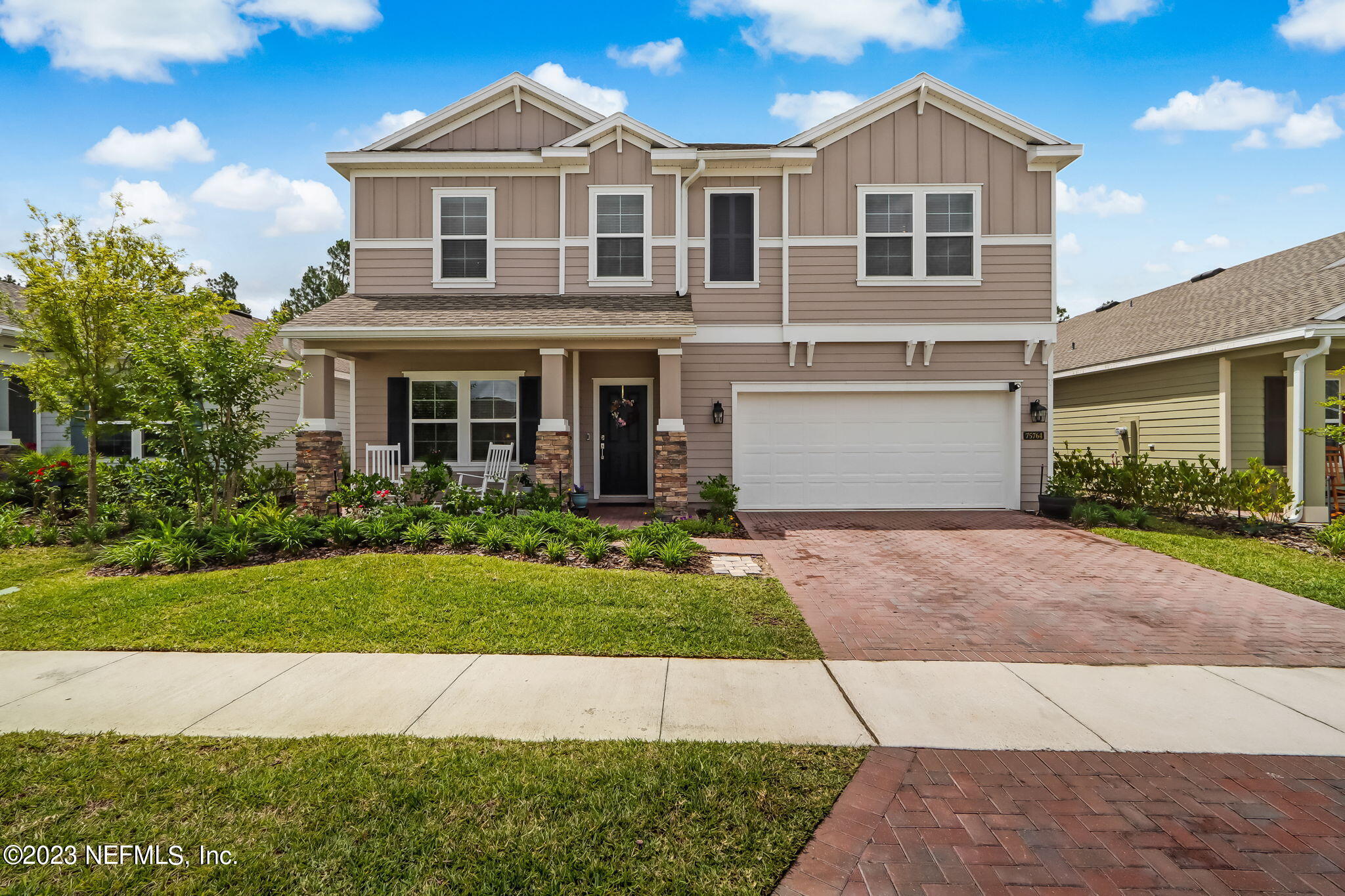 75764 Spoonbill Lane Yulee, FL 32097 - Photo 1 of 34 a front view of a house with a yard and garage