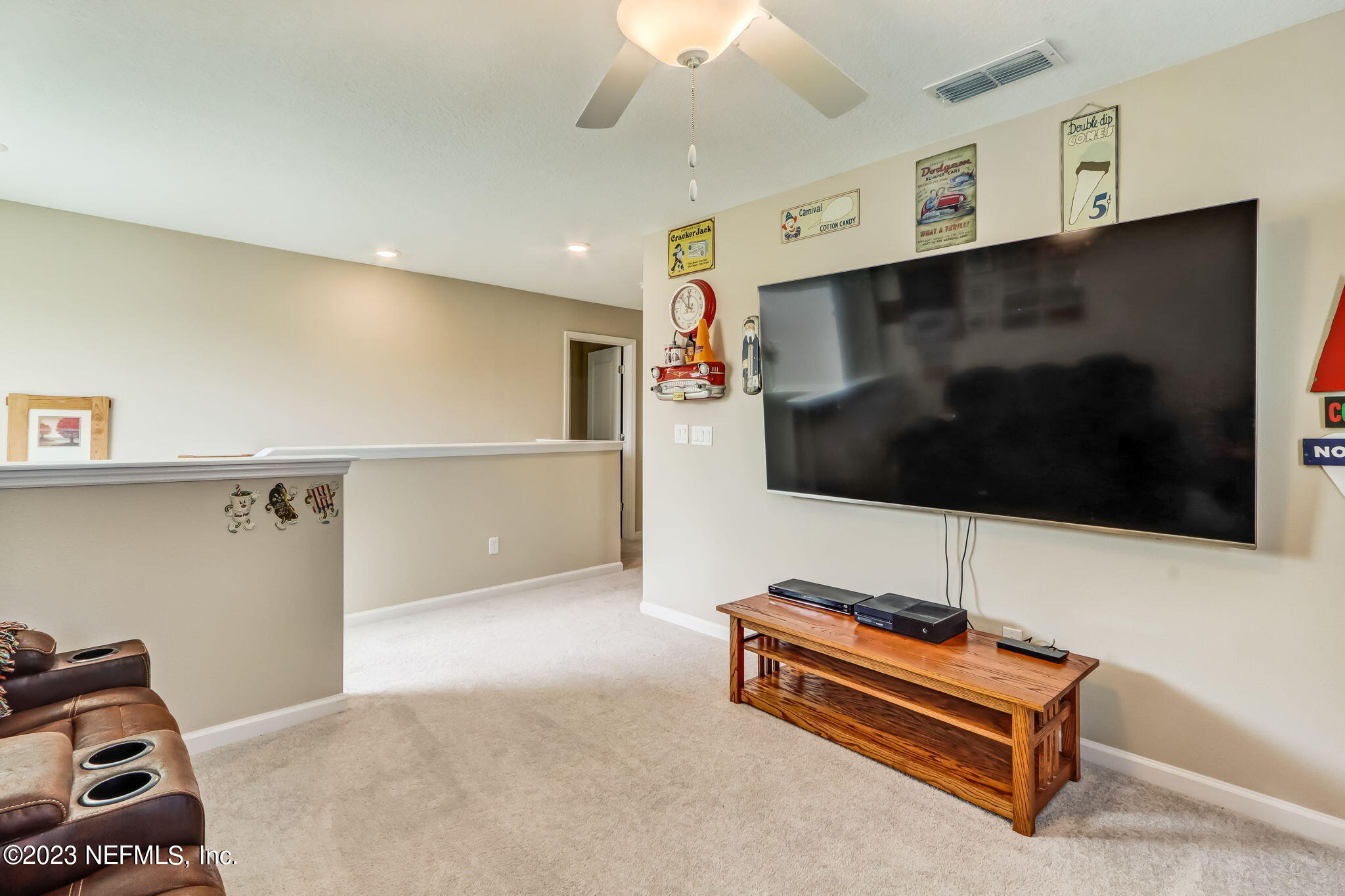 75764 Spoonbill Lane Yulee, FL 32097 - Photo 12 of 34 a living room with furniture and a flat screen tv