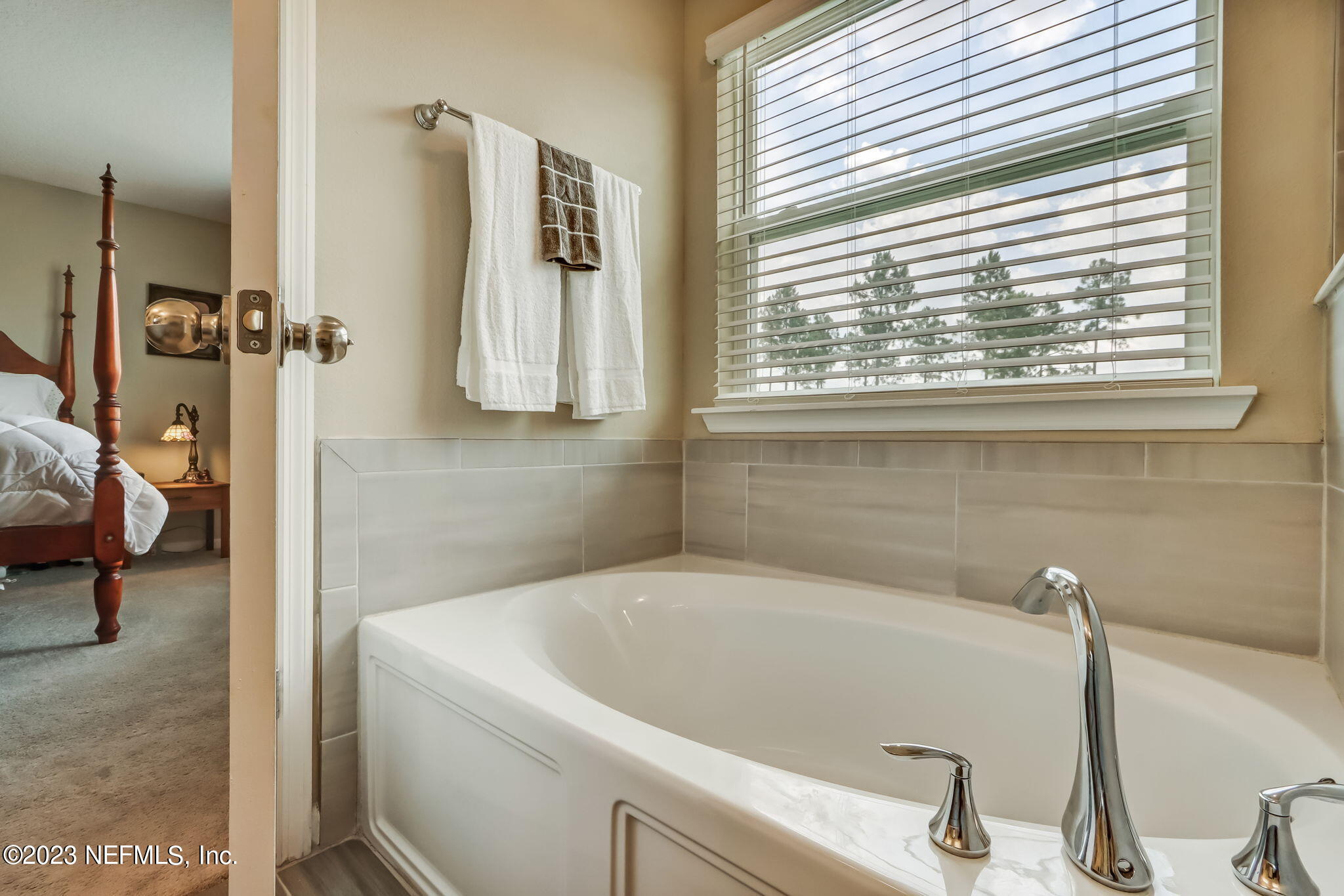 75764 Spoonbill Lane Yulee, FL 32097 - Photo 15 of 34 a bathroom with a tub and a window