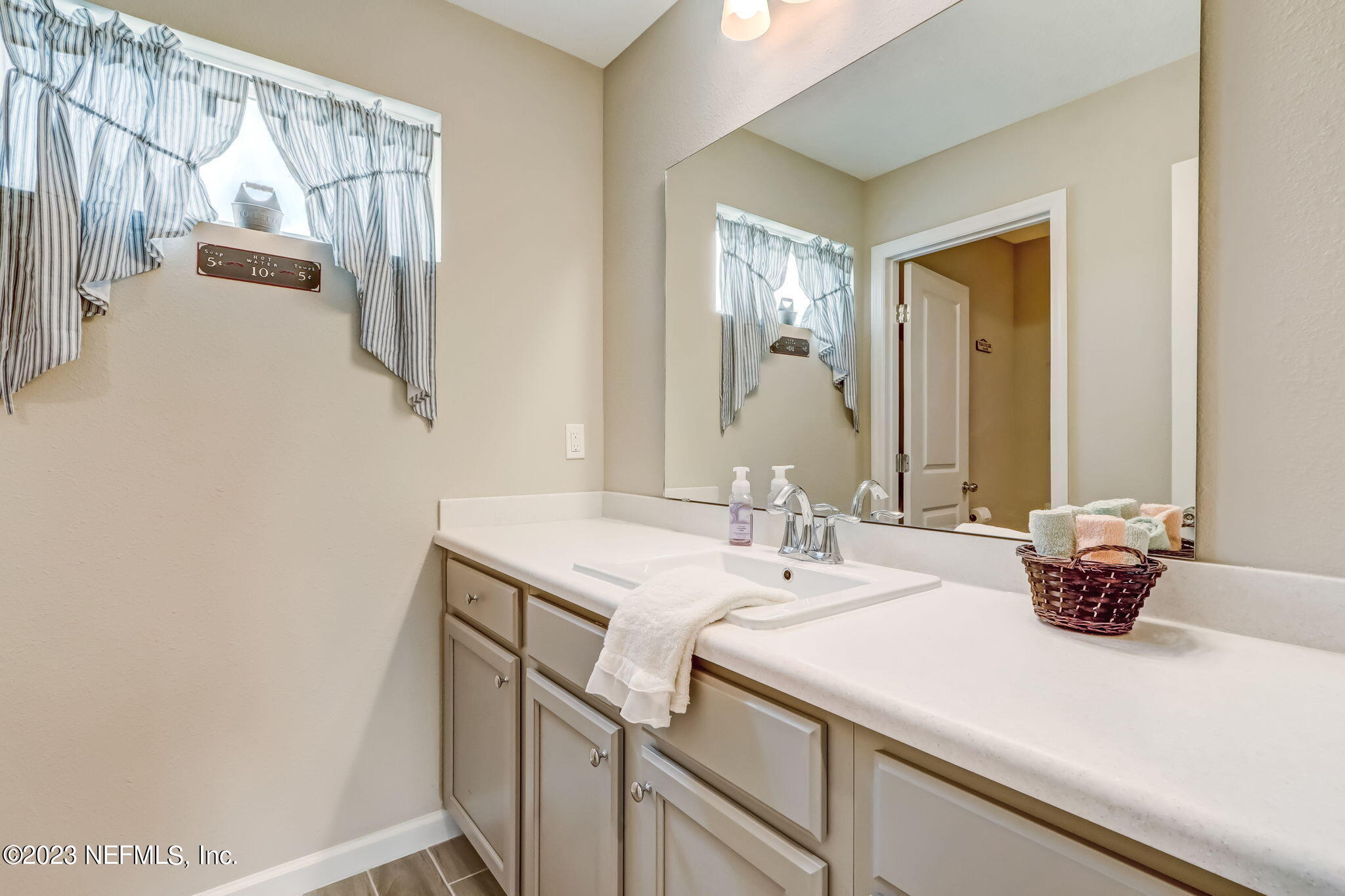 75764 Spoonbill Lane Yulee, FL 32097 - Photo 17 of 34 a bathroom with a sink and a mirror