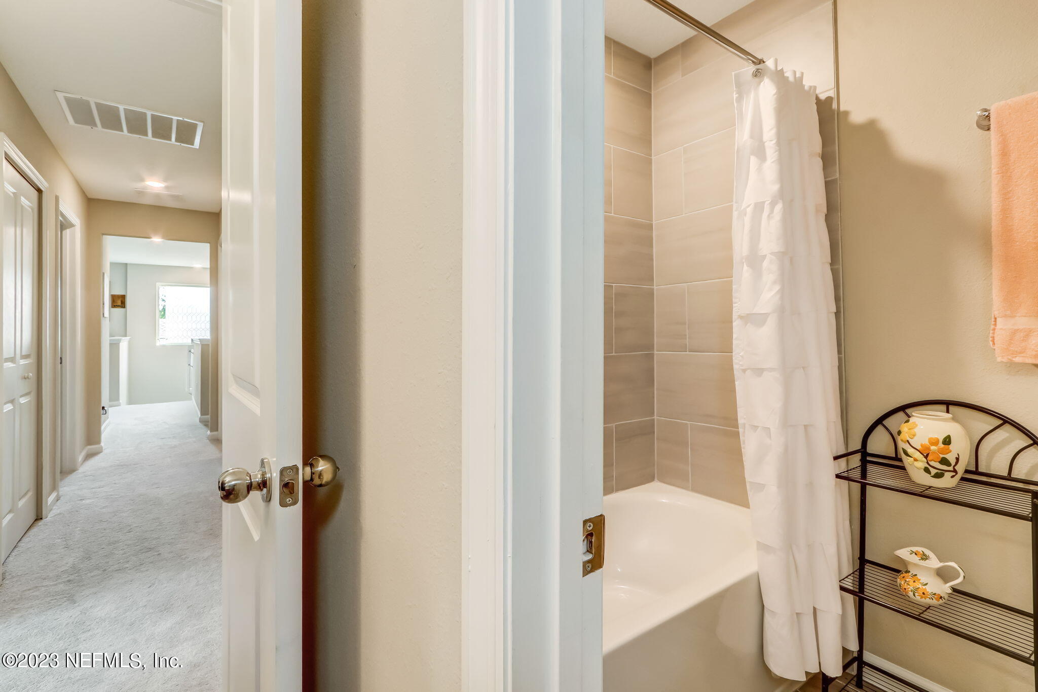 75764 Spoonbill Lane Yulee, FL 32097 - Photo 18 of 34 a bathroom with a sink a mirror and a shower