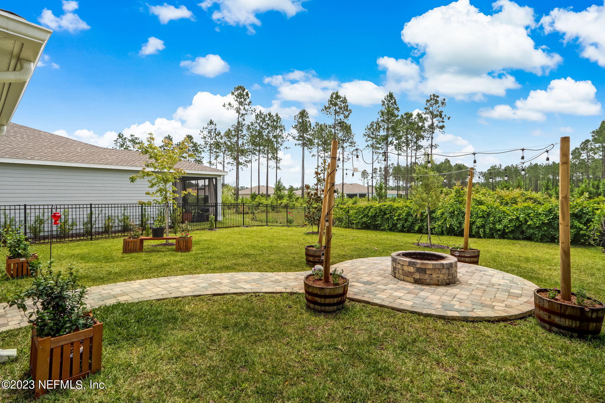 75764 Spoonbill Lane Yulee, FL 32097 - Photo 22 of 34 a swimming pool with lots of green space and outdoor seating