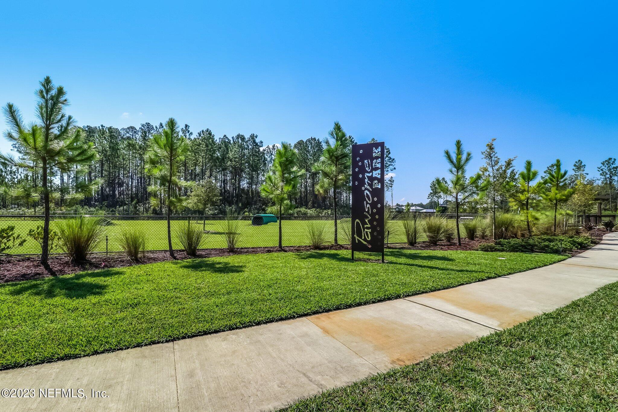 75764 Spoonbill Lane Yulee, FL 32097 - Photo 29 of 34 a view of a park with a palm and plants
