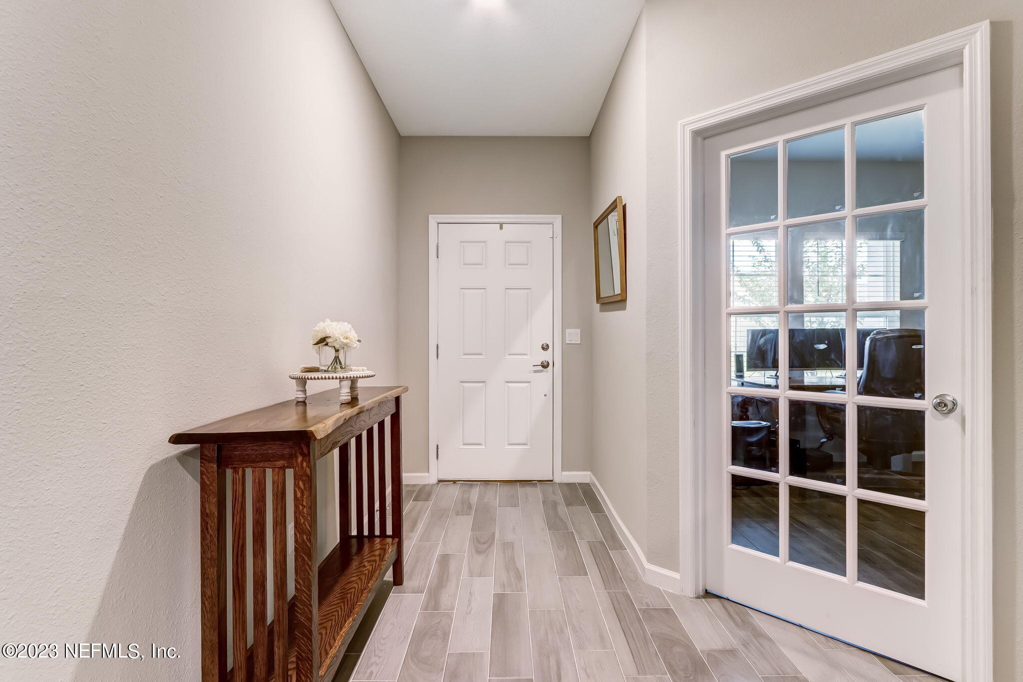 75764 Spoonbill Lane Yulee, FL 32097 - Photo 4 of 34 a view of a hallway with wooden floor and entryway