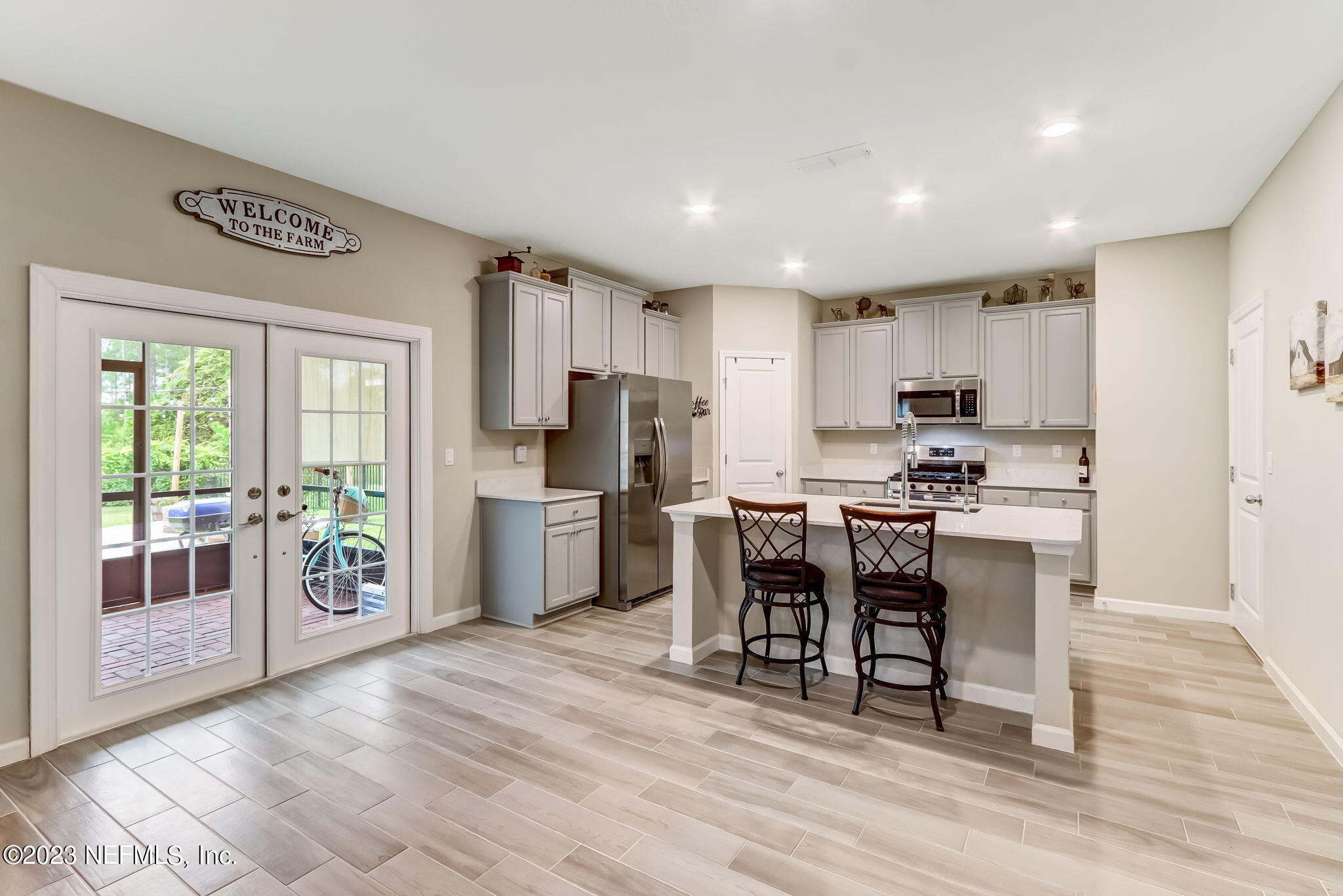 75764 Spoonbill Lane Yulee, FL 32097 - Photo 8 of 34 a kitchen with refrigerator cabinets and wooden floor