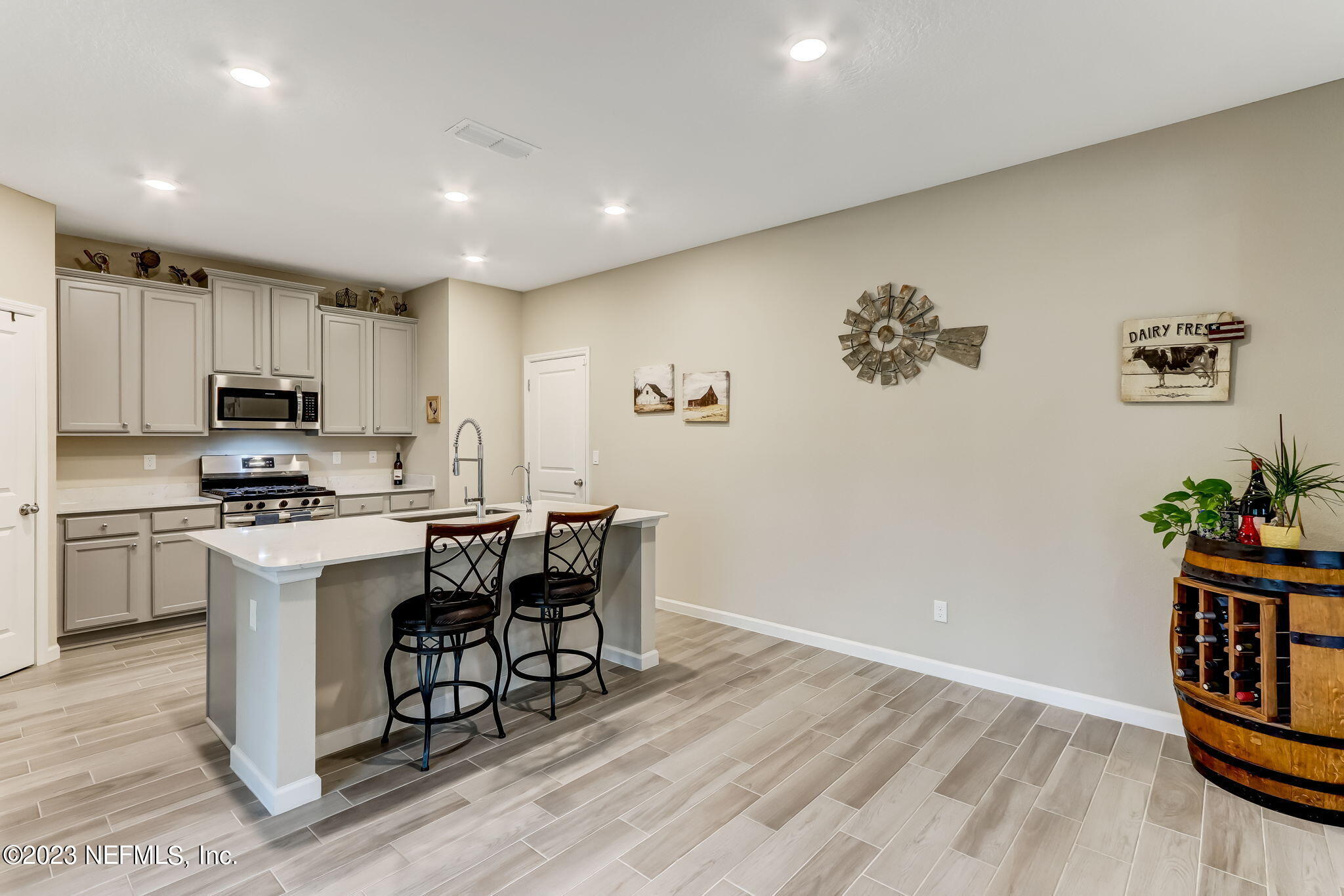 75764 Spoonbill Lane Yulee, FL 32097 - Photo 9 of 34 a kitchen with a refrigerator and a stove top oven