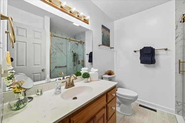 a bathroom with a sink toilet and mirror