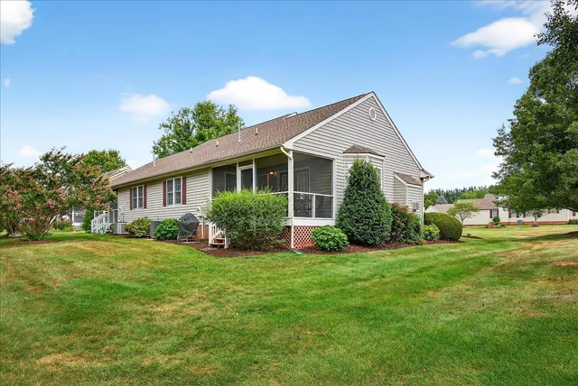 a front view of house with yard and green space