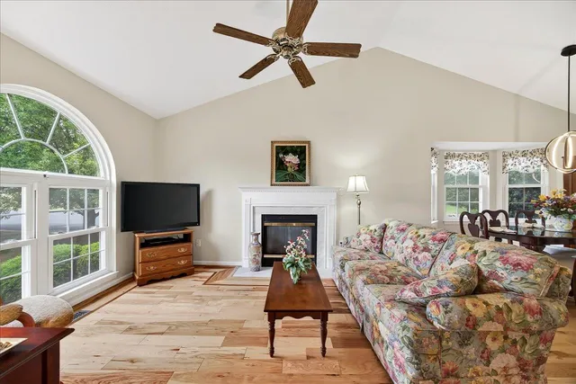 a living room with furniture a fireplace and a flat screen tv