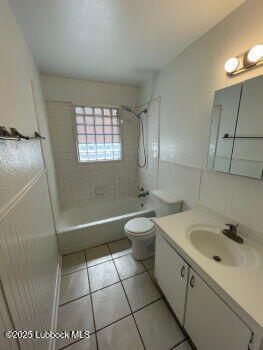 4315 41st Street Lubbock, TX 79413 - Photo 9 of 14 a bathroom with a sink a toilet and mirror