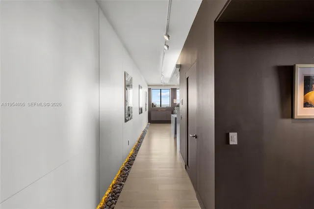 a view of hallway with wooden floor