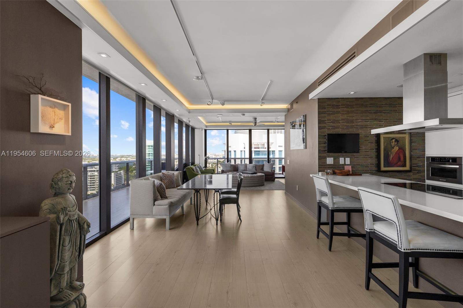 5875 Collins Avenue, Unit PH7 Miami Beach, FL 33140 - Photo 22 of 49 a living room with fireplace furniture and a large window