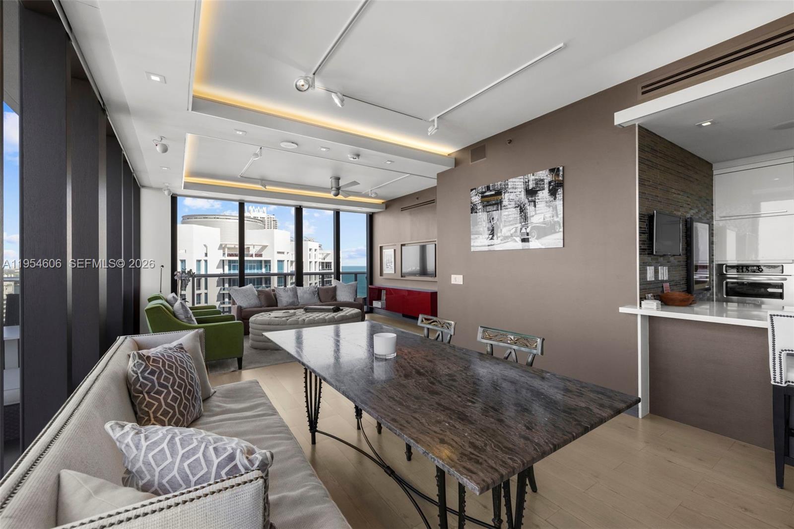 5875 Collins Avenue, Unit PH7 Miami Beach, FL 33140 - Photo 23 of 49 a living room with furniture and a table