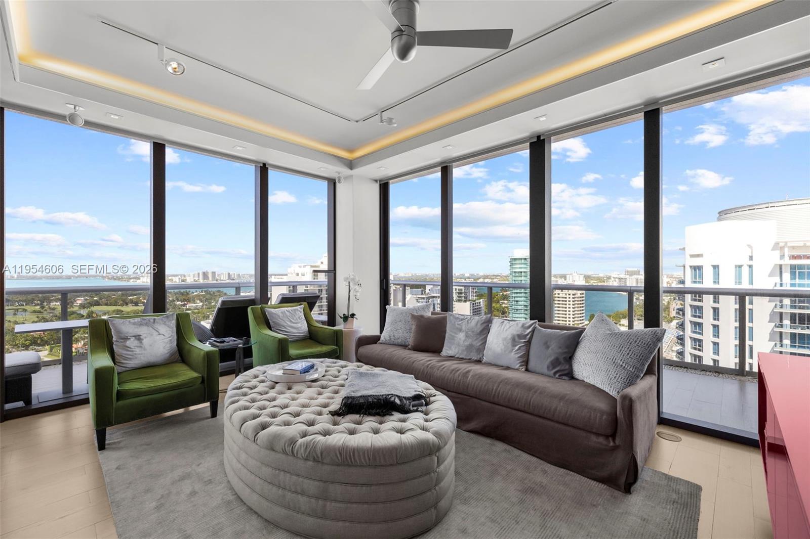 5875 Collins Avenue, Unit PH7 Miami Beach, FL 33140 - Photo 25 of 49 a living room with furniture and floor to ceiling windows