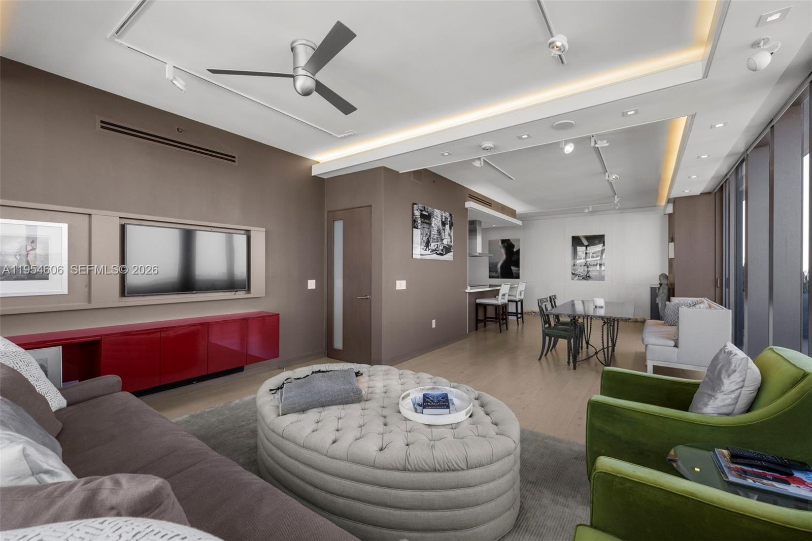 5875 Collins Avenue, Unit PH7 Miami Beach, FL 33140 - Photo 27 of 49 a living room with furniture and wooden floor