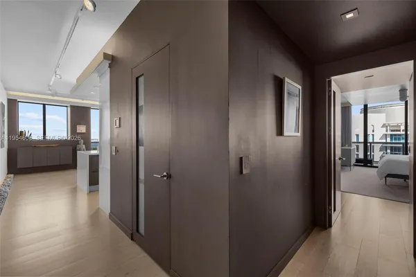 a view of a hallway with a livingroom and furniture