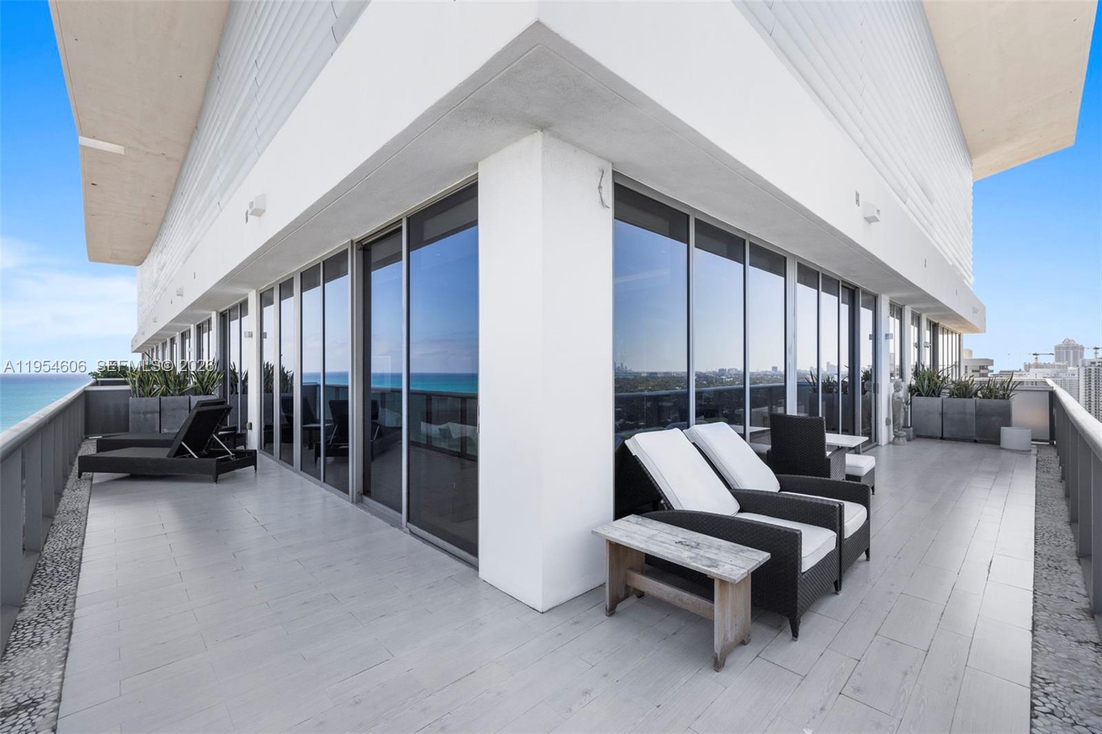 5875 Collins Avenue, Unit PH7 Miami Beach, FL 33140 - Photo 33 of 49 a building outdoor space with patio furniture