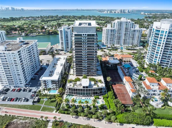 an aerial view of lake and residential houses with outdoor space