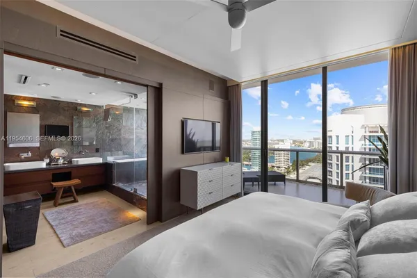 a bedroom with a large bed and a balcony view