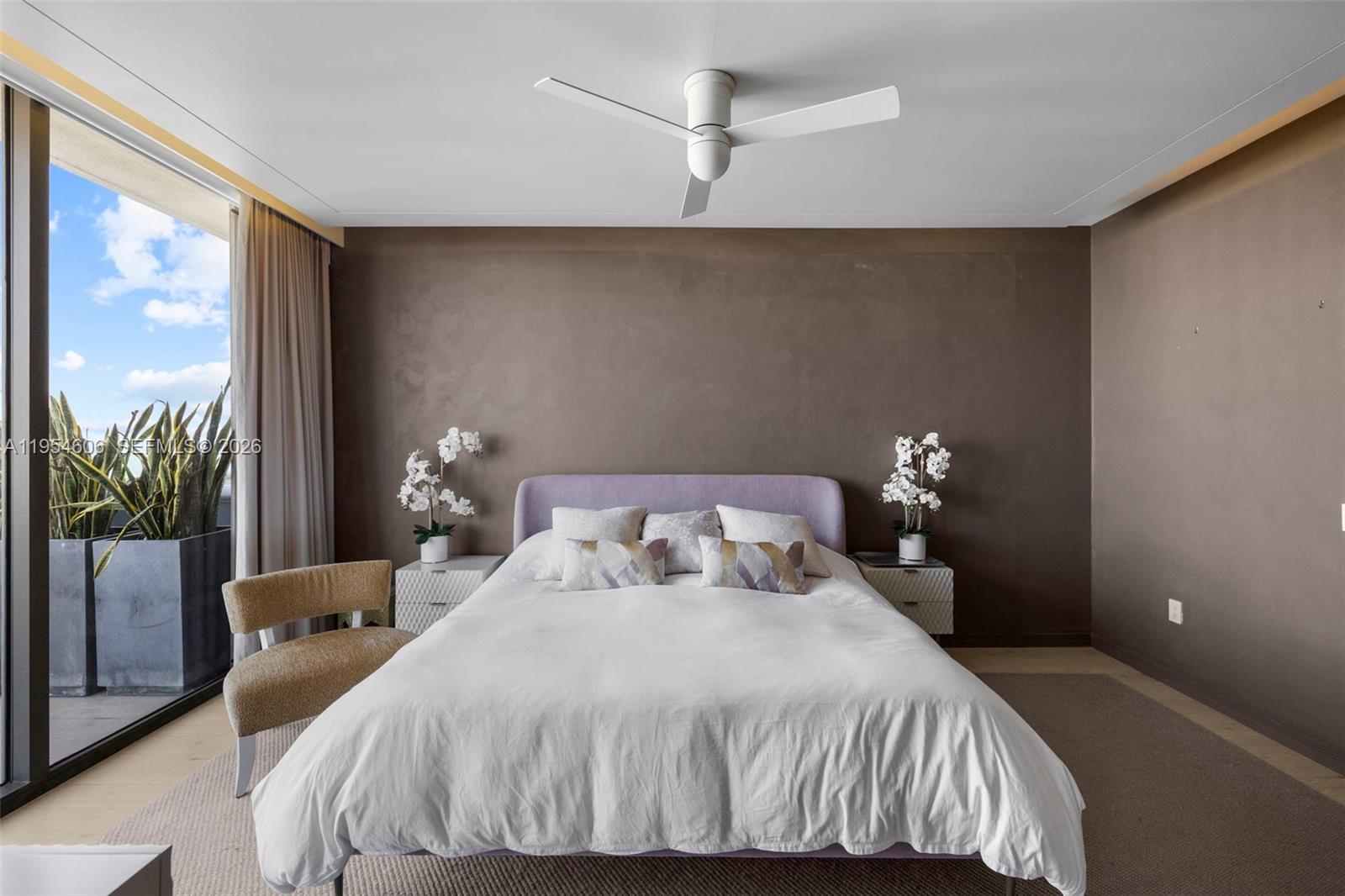 5875 Collins Avenue, Unit PH7 Miami Beach, FL 33140 - Photo 7 of 49 a bedroom with a bed and a potted plant