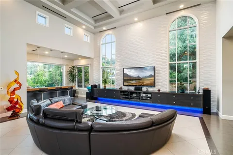 a kitchen with a sink refrigerator and chairs