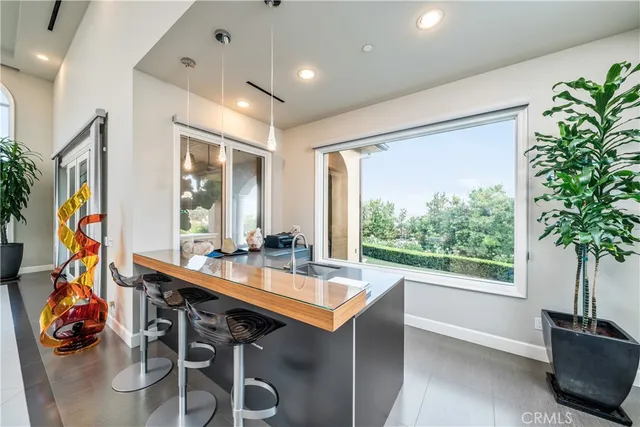 a kitchen with kitchen island a sink appliances and cabinets