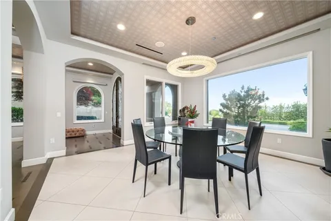 a living room with furniture a flat screen tv and a large window