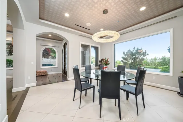 a living room with furniture a flat screen tv and a large window