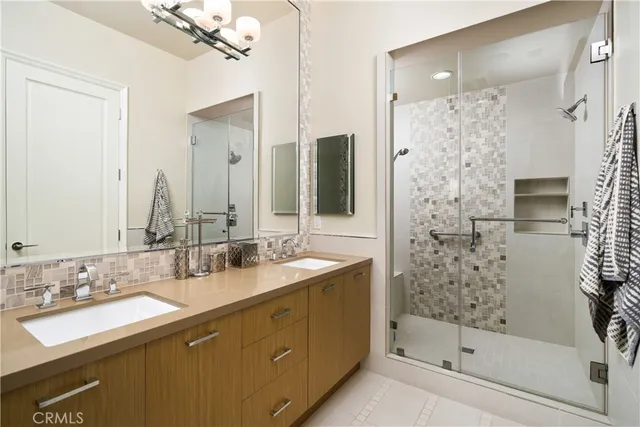 a bathroom with a granite countertop sink toilet a mirror and shower