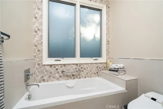 a bedroom with furniture and a large window