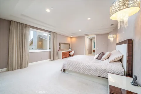 a bedroom with a bed and a large window