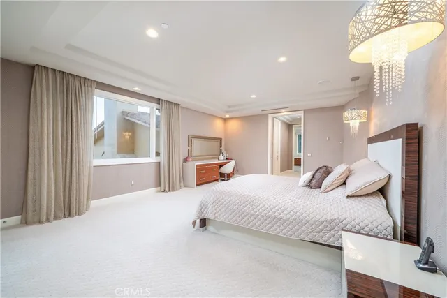 a bedroom with a bed and a large window